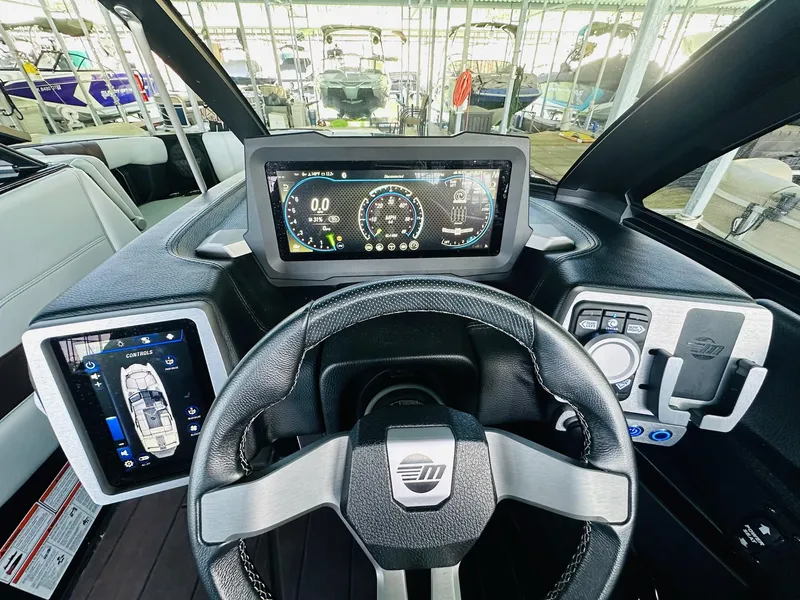 Slide: The Image of 2022 Malibu Wakesetter 24 MXZ dashboard with digital displays and steering wheel. - 16