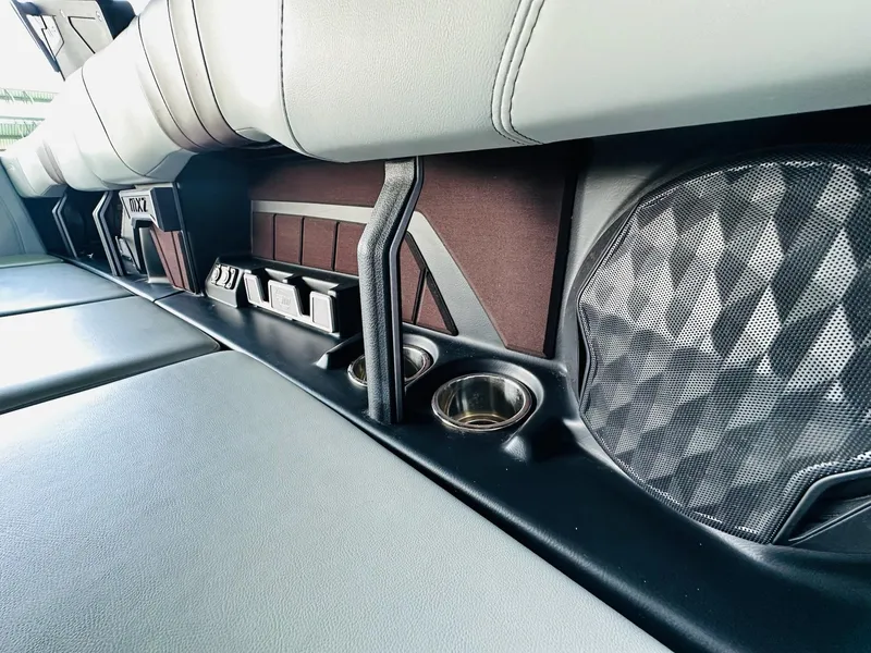 Slide: The Image of 2022 Malibu Wakesetter 24 MXZ interior with cup holders and speaker detail. - 18