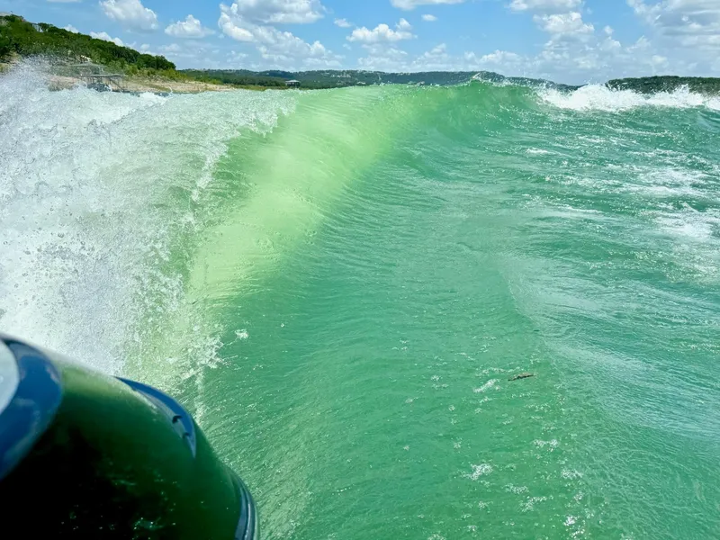Slide: The Image of Wakesurfing wave created by 2022 Malibu Wakesetter 24 MXZ on a sunny day. - 22