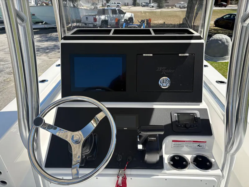Slide: The Image of Bay Rider 2260 Skiff 2025 console with steering wheel and controls. - 6