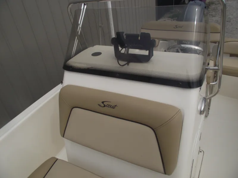 Slide: The Image of 2018 Scout 175 Sportfish boat console with beige seating and windshield. - 11