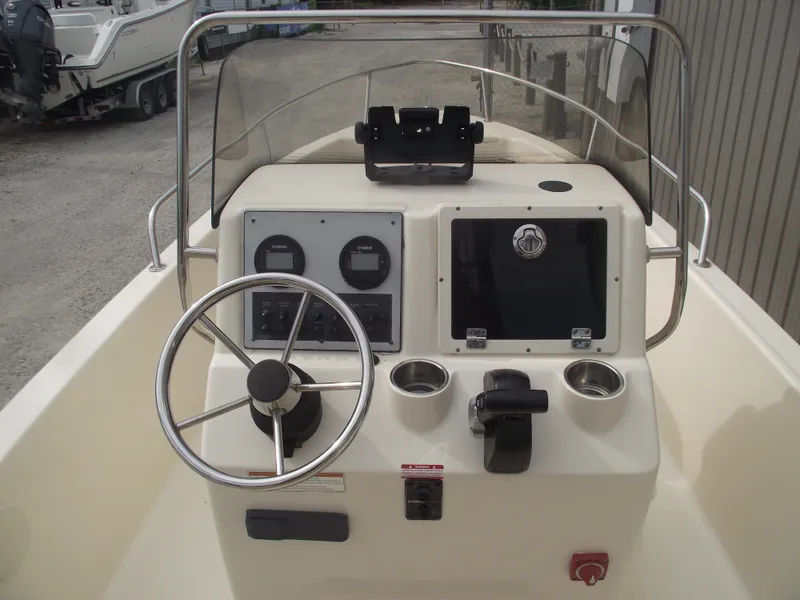 Slide: The Image of 2018 Scout 175 Sportfish boat console with steering wheel and gauges. - 17