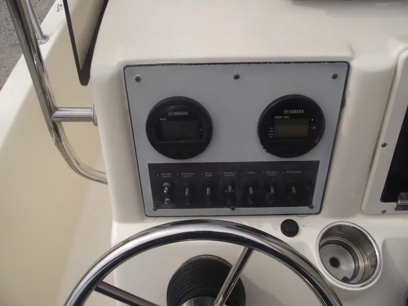 Slide: The Image of 2018 Scout 175 Sportfish dashboard with Yamaha gauges and steering wheel. - 18