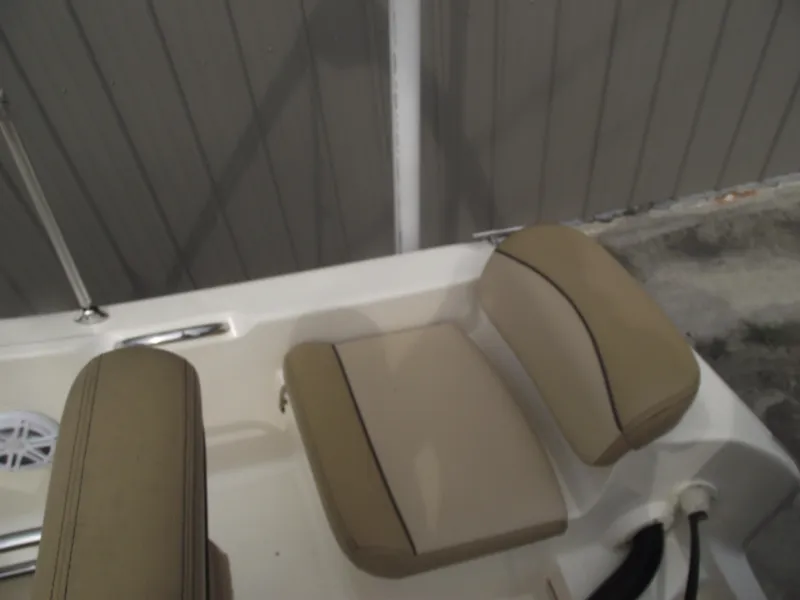 Slide: The Image of 2018 Scout 175 Sportfish boat seat with beige cushions and sleek design. - 26