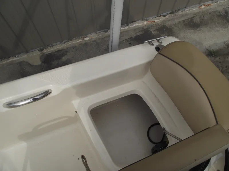 Slide: The Image of 2018 Scout 175 Sportfish boat interior with storage compartment and beige seating. - 27