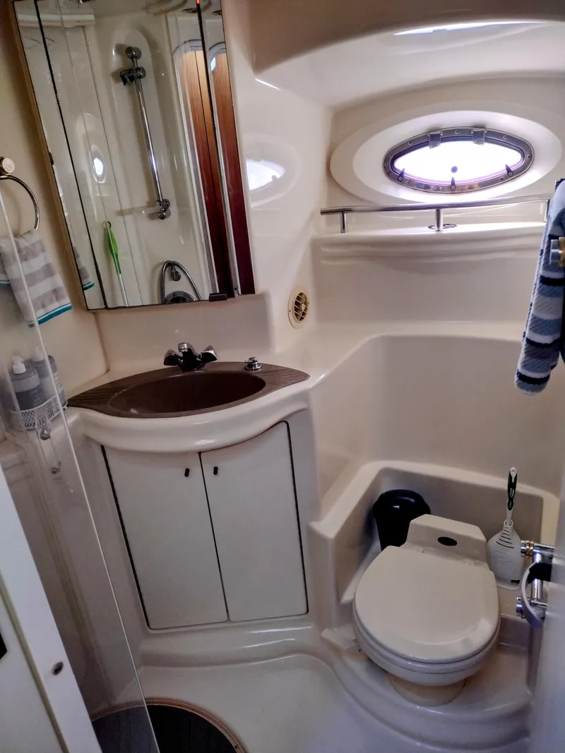 Slide: The Image of 1999 Maxum 4600 SCB yacht bathroom with sink, toilet, and shower. - 14
