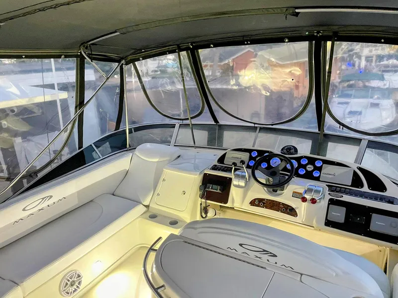 Slide: The Image of Interior view of 1999 Maxum 4600 SCB yacht cockpit with modern controls and seating. - 3