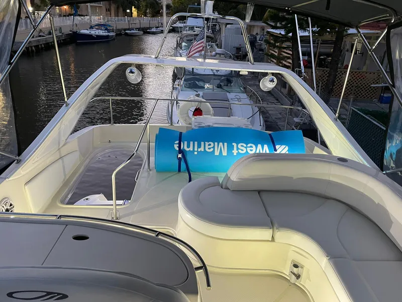 Slide: The Image of 1999 Maxum 4600 SCB yacht with spacious deck and seating, docked at marina. - 5