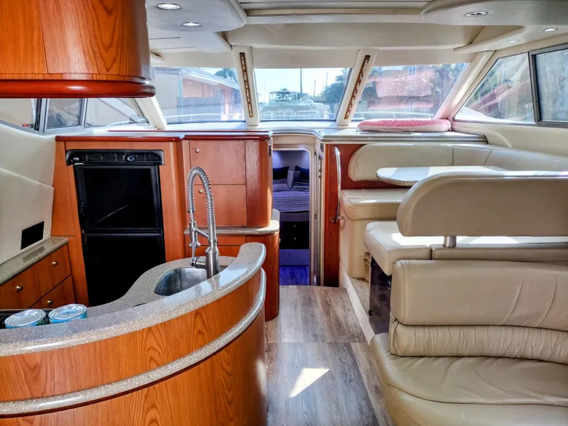 Slide: The Image of Interior of 1999 Maxum 4600 SCB yacht with modern kitchen and seating area. - 7