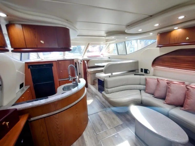 Slide: The Image of Luxurious 1999 Maxum 4600 SCB yacht interior with modern kitchen and spacious seating area. - 8
