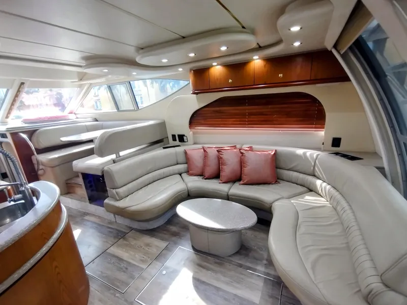 Slide: The Image of Luxurious 1999 Maxum 4600 SCB yacht interior with curved seating and modern design. - 9