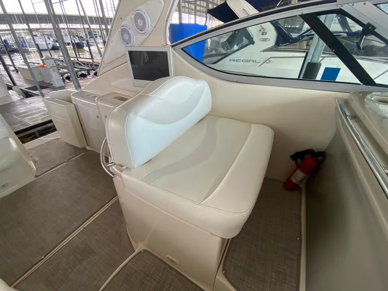Slide: The Image of 1998 Maxum 3700 SCR boat interior with white seating and control panel. - 10