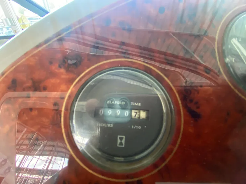 Slide: The Image of Hour meter on 1998 Maxum 3700 SCR boat dashboard showing 990.7 hours. - 16