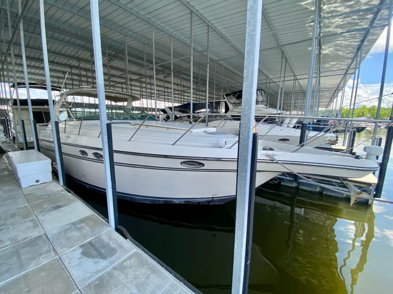 Slide: The Image of 1998 Maxum 3700 SCR yacht docked in a covered marina. - 2