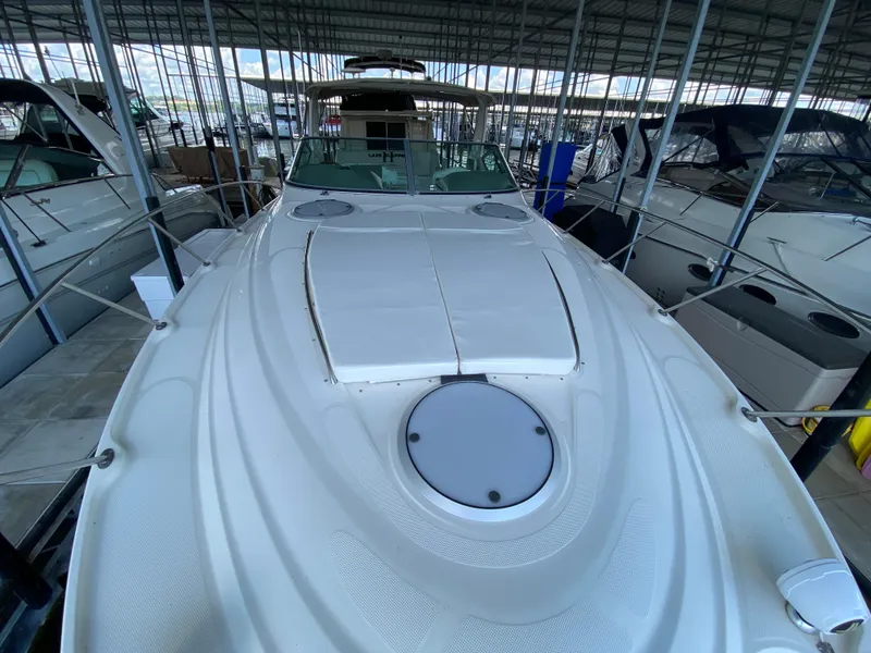 Slide: The Image of 1998 Maxum 3700 SCR yacht docked in a marina, viewed from the bow. - 21