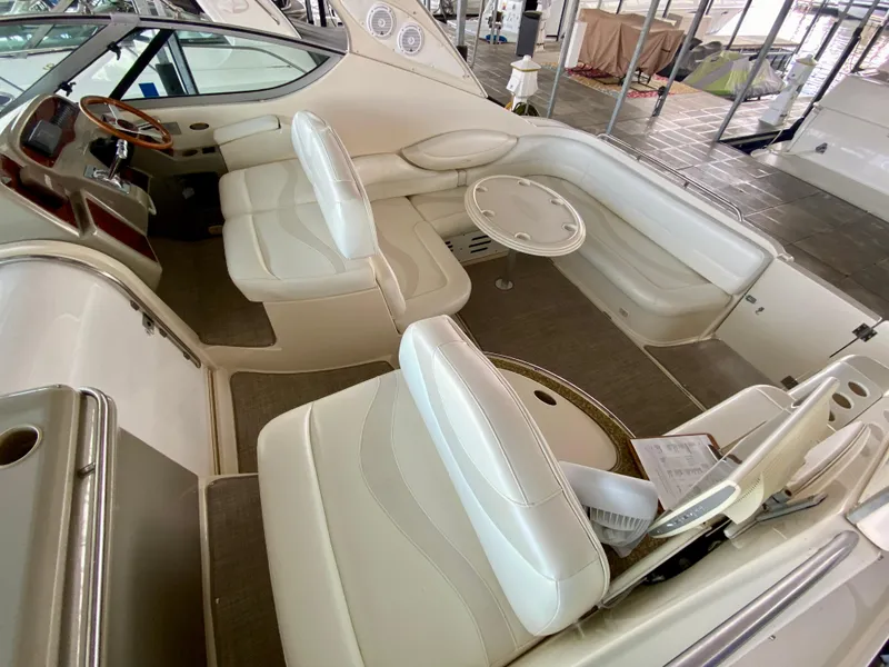 Slide: The Image of 1998 Maxum 3700 SCR boat interior with white seating and steering wheel. - 23