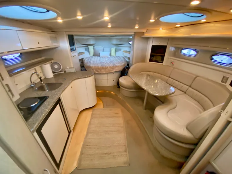 Slide: The Image of Luxurious interior of a 1998 Maxum 3700 SCR yacht with kitchen and seating area. - 25