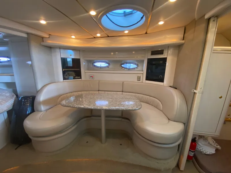 Slide: The Image of Luxurious interior of 1998 Maxum 3700 SCR yacht with plush seating and elegant table. - 26