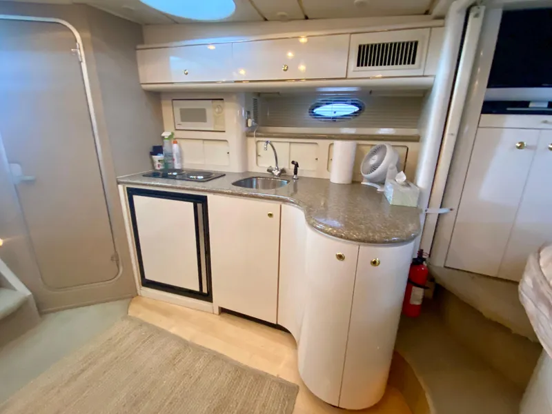 Slide: The Image of Interior of 1998 Maxum 3700 SCR yacht with kitchenette and modern amenities. - 28
