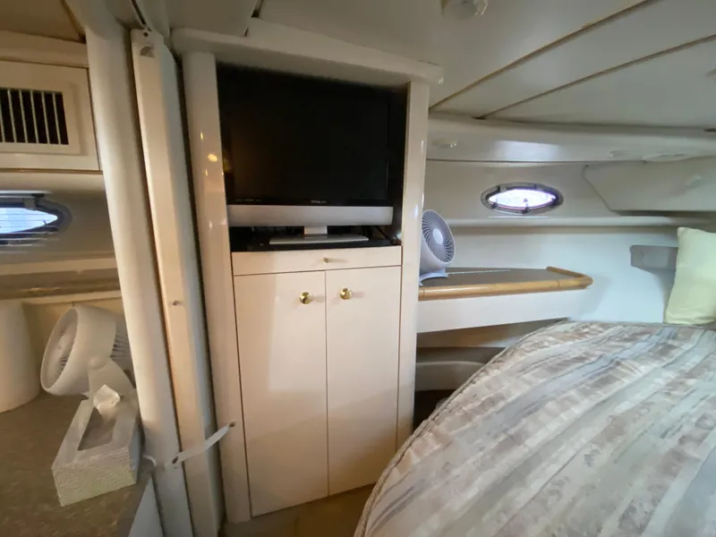 Slide: The Image of 1998 Maxum 3700 SCR cabin interior with TV, fan, and bed. - 30
