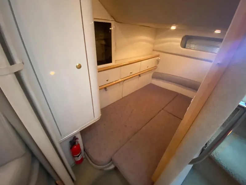 Slide: The Image of 1998 Maxum 3700 SCR cabin interior with bed, storage, and window. - 35
