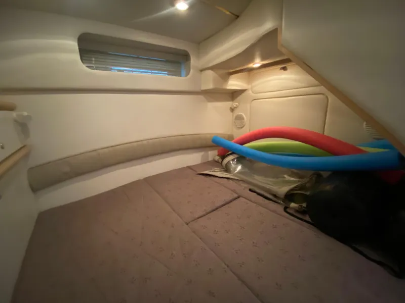 Slide: The Image of Interior cabin of 1998 Maxum 3700 SCR with bed and colorful pool noodles. - 36