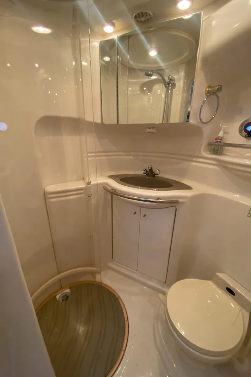 Slide: The Image of 1998 Maxum 3700 SCR yacht bathroom with shower, sink, and toilet. - 37