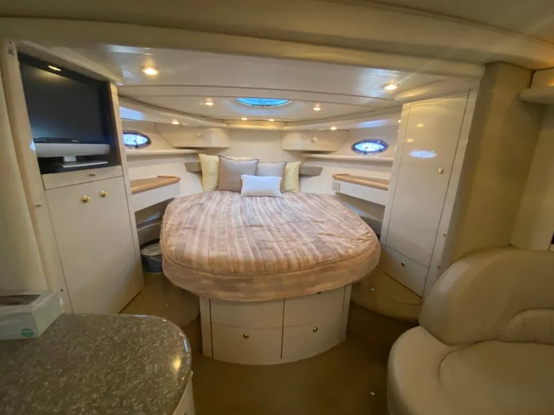 Slide: The Image of 1998 Maxum 3700 SCR yacht interior with cozy bed, TV, and elegant lighting. - 44