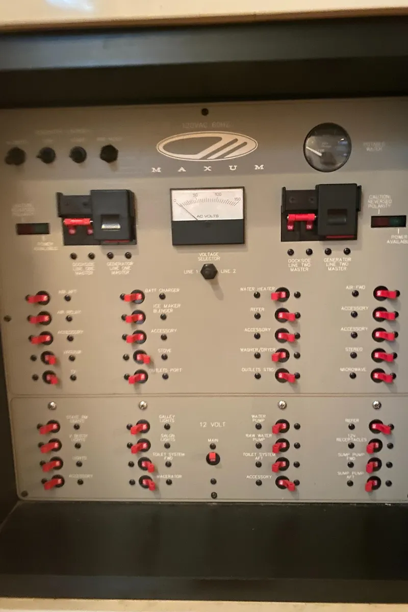 Slide: The Image of Electrical control panel of a 1998 Maxum 3700 SCR boat with switches and gauges. - 47