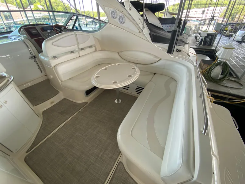 Slide: The Image of 1998 Maxum 3700 SCR yacht interior with white seating and round table. - 5