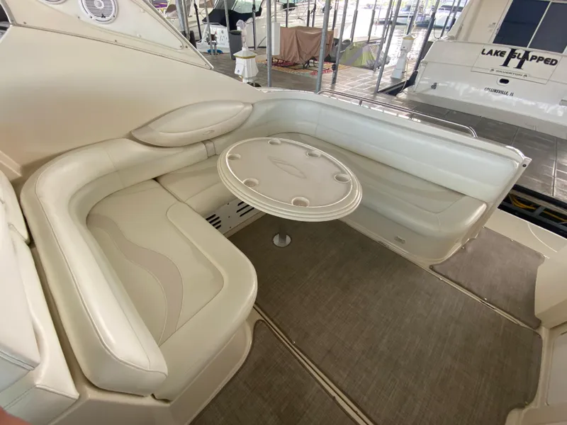 Slide: The Image of 1998 Maxum 3700 SCR yacht interior with cream leather seating and round table. - 6