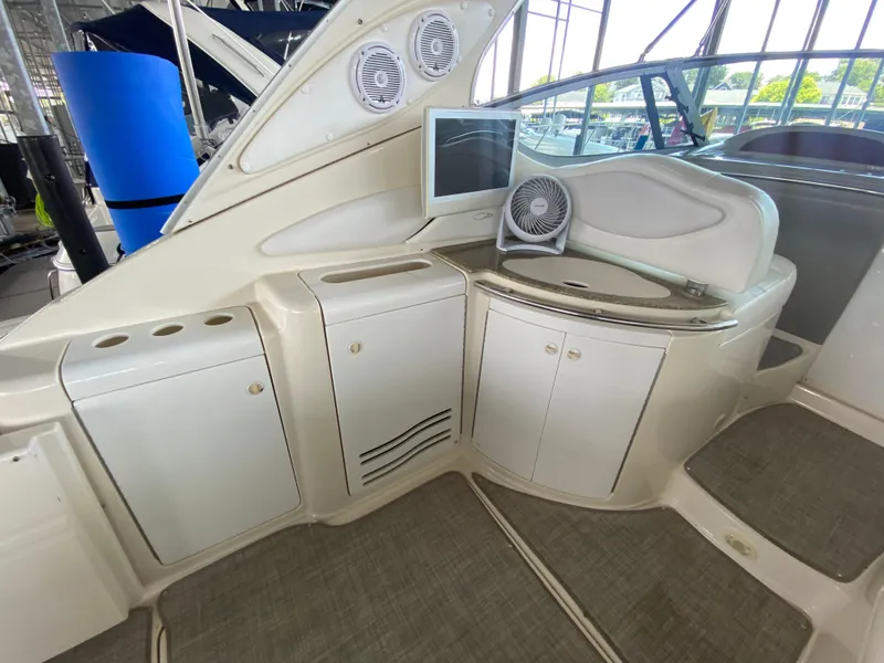 Slide: The Image of 1998 Maxum 3700 SCR yacht interior with cabinets, sink, and fan in a sleek design. - 8
