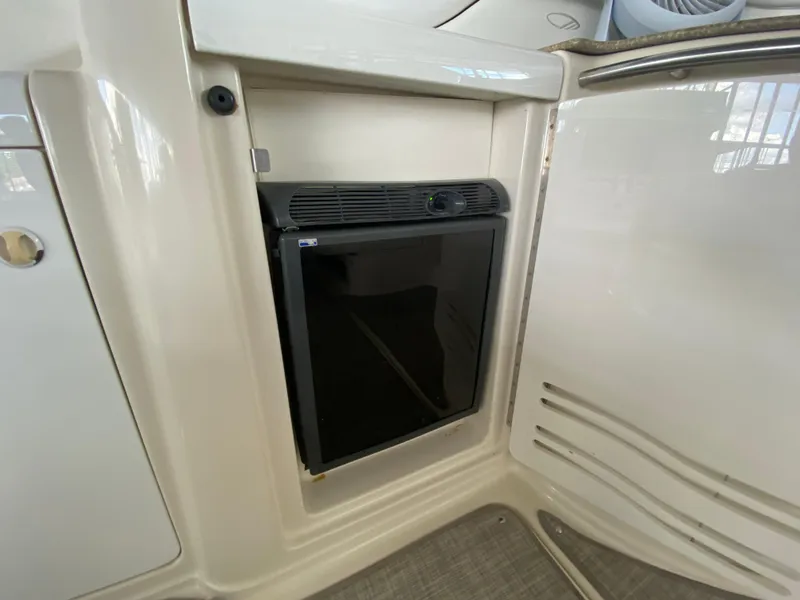 Slide: The Image of 1998 Maxum 3700 SCR boat interior with built-in mini fridge. - 9