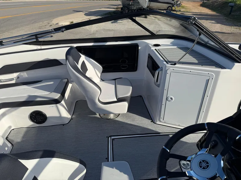 Slide: The Image of 2025 Yamaha Boats SX195 interior with sleek seating and modern dashboard design. - 10