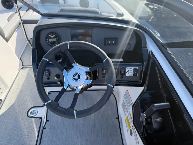 Slide: The Image of 2025 Yamaha Boats SX195 steering wheel and dashboard, featuring modern controls and sleek design. - 9
