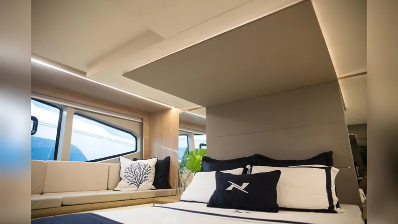 Slide: The Image of Luxurious interior of 2025 NX Boats NX50 Invictus HT with elegant bedding and seating. - 15