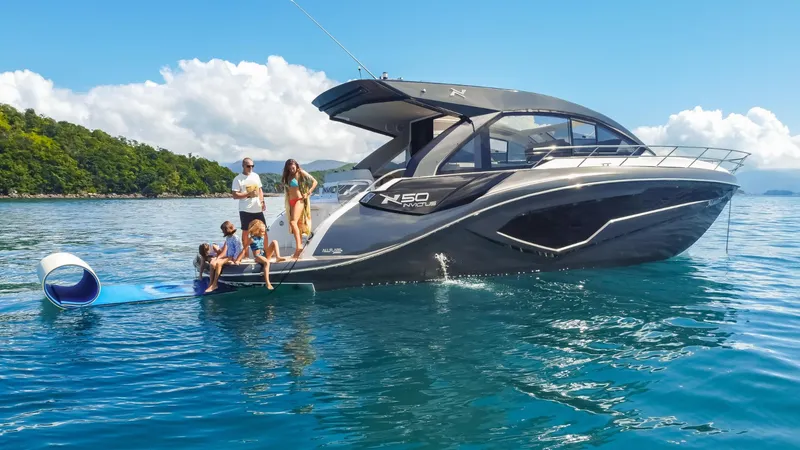 Slide: The Image of 2025 NX Boats NX50 Invictus HT yacht on water with people enjoying the sun. - 20