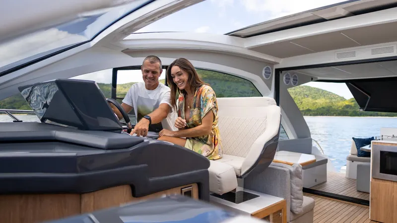 Slide: The Image of Couple enjoying the 2025 NX Boats NX50 Invictus HT yacht interior. - 23