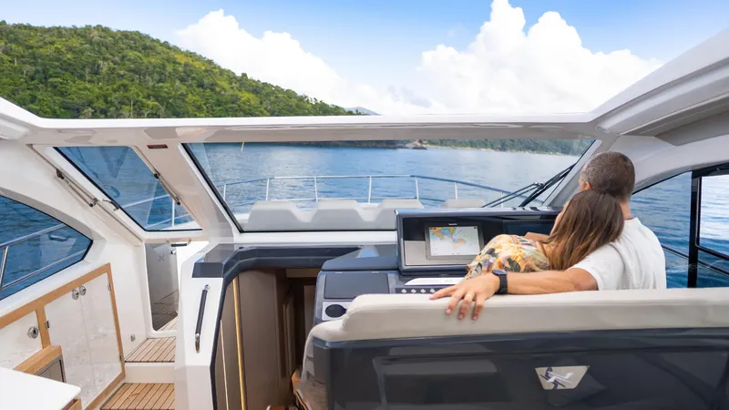 Slide: The Image of Couple enjoying a scenic view aboard the 2025 NX Boats NX50 Invictus HT yacht. - 24