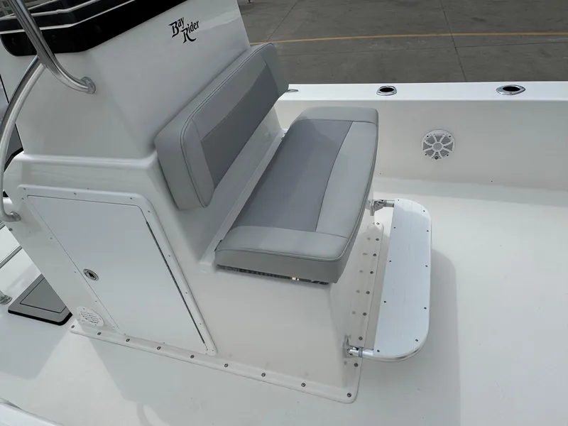 Slide: The Image of Bay Rider 2060 Skiff 2025 boat seat and console, featuring gray cushions and storage compartment. - 8