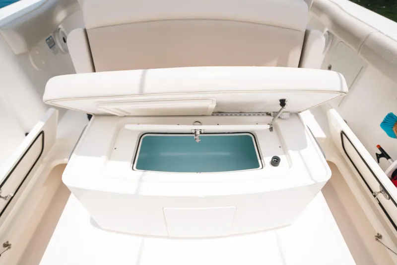 Slide: The Image of 2019 Boston Whaler 330 Outrage boat interior with open storage compartment. - 13