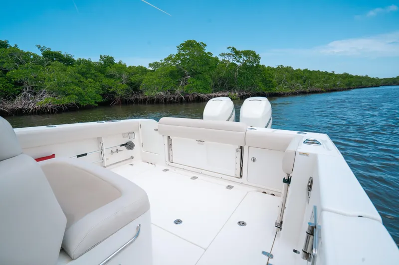 Slide: The Image of 2019 Boston Whaler 330 Outrage boat on calm water near lush green mangroves. - 15
