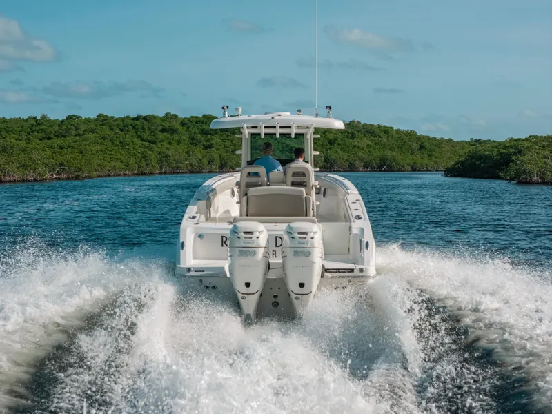Slide: The Image of 2019 Boston Whaler 330 Outrage cruising on a scenic waterway. - 18