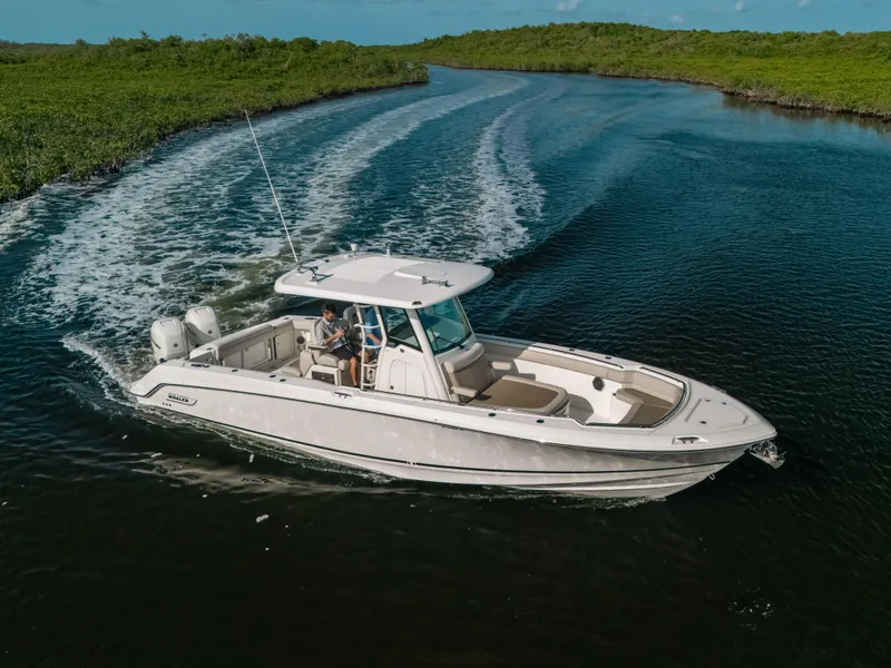 Slide: The Image of 2019 Boston Whaler 330 Outrage cruising on a scenic waterway. - 20