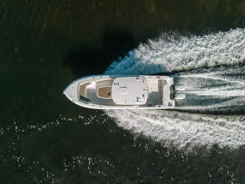 Slide: The Image of Aerial view of 2019 Boston Whaler 330 Outrage speeding on water. - 25
