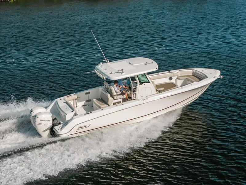 Slide: The Image of 2019 Boston Whaler 330 Outrage cruising on open water, showcasing sleek design and powerful performance. - 3