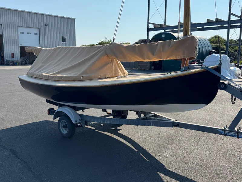 Slide: The Image of Custom 2004 Barnstable Cat Boat on trailer, covered, near industrial building. - 3