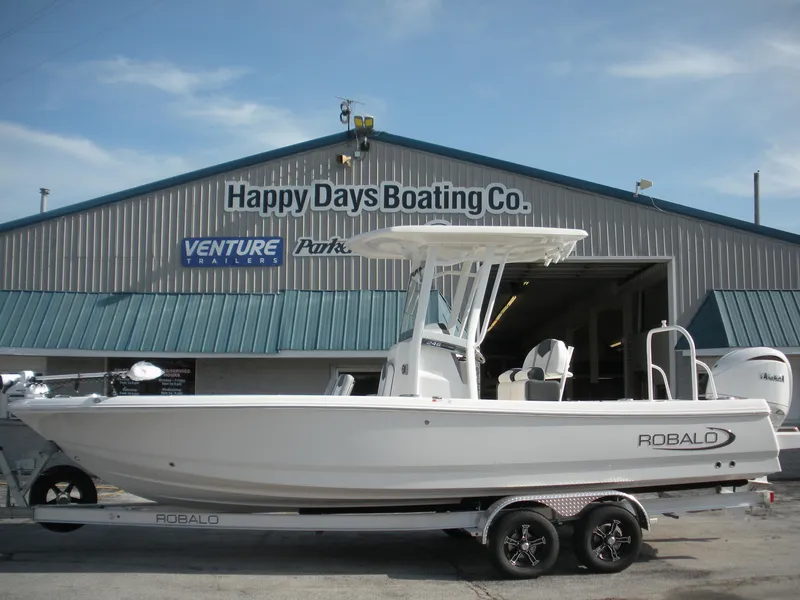 The Image of 2026 Robalo R246 Caymann boat on trailer at Happy Days Boating Co. dealership. - 0
