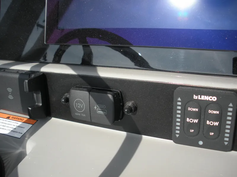 Slide: The Image of Control panel of 2026 Robalo R246 Caymann boat with Lenco trim tab switches. - 11