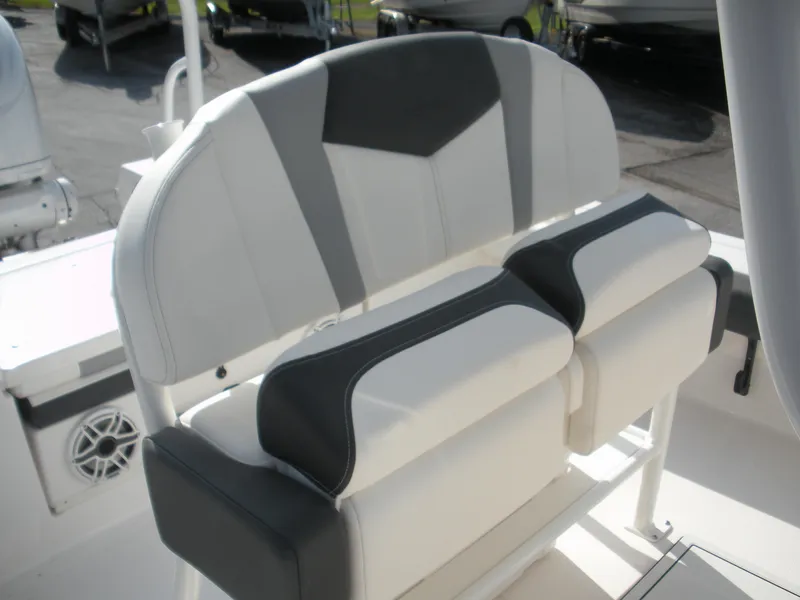Slide: The Image of 2026 Robalo R246 Caymann boat seating with white and gray upholstery. - 12